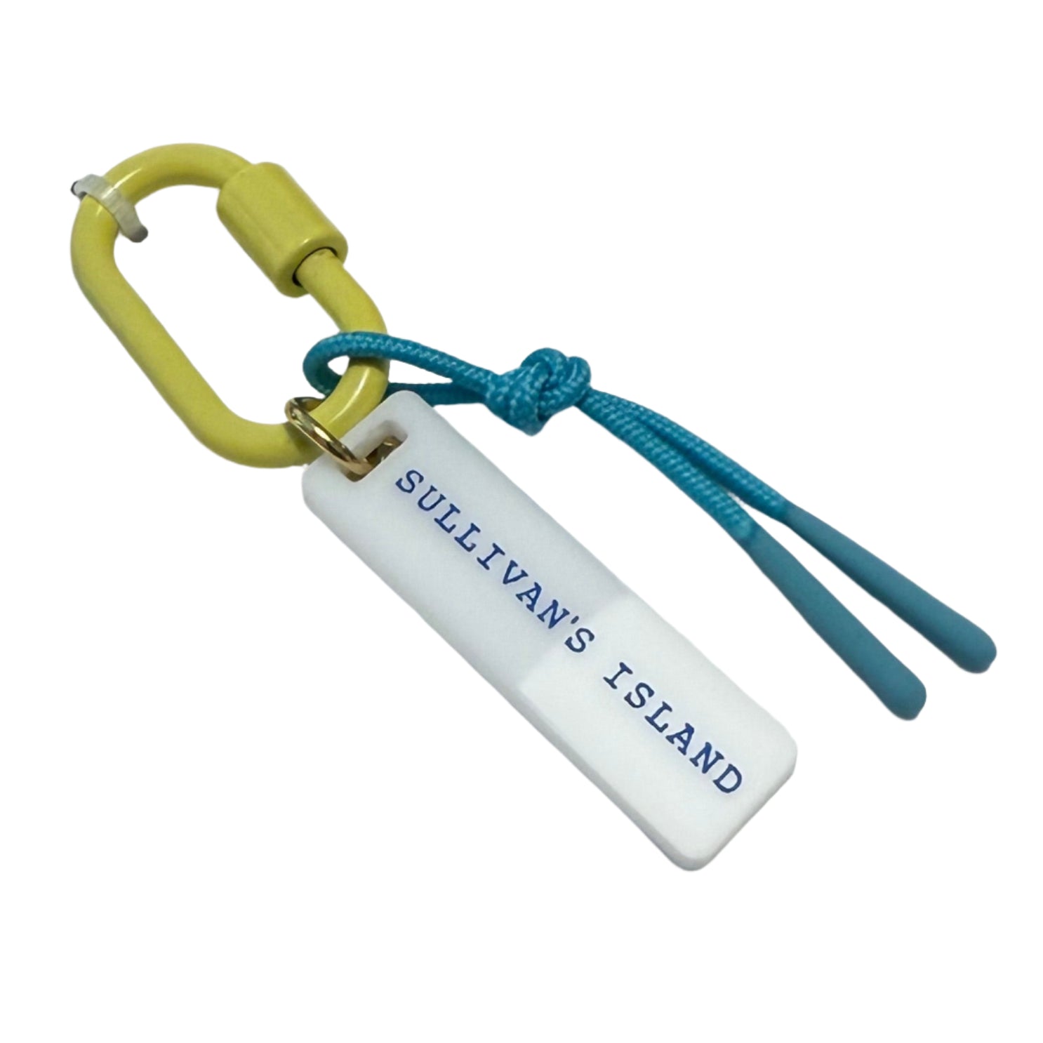 Bag charm on a display card with a blue label on a wooden surface