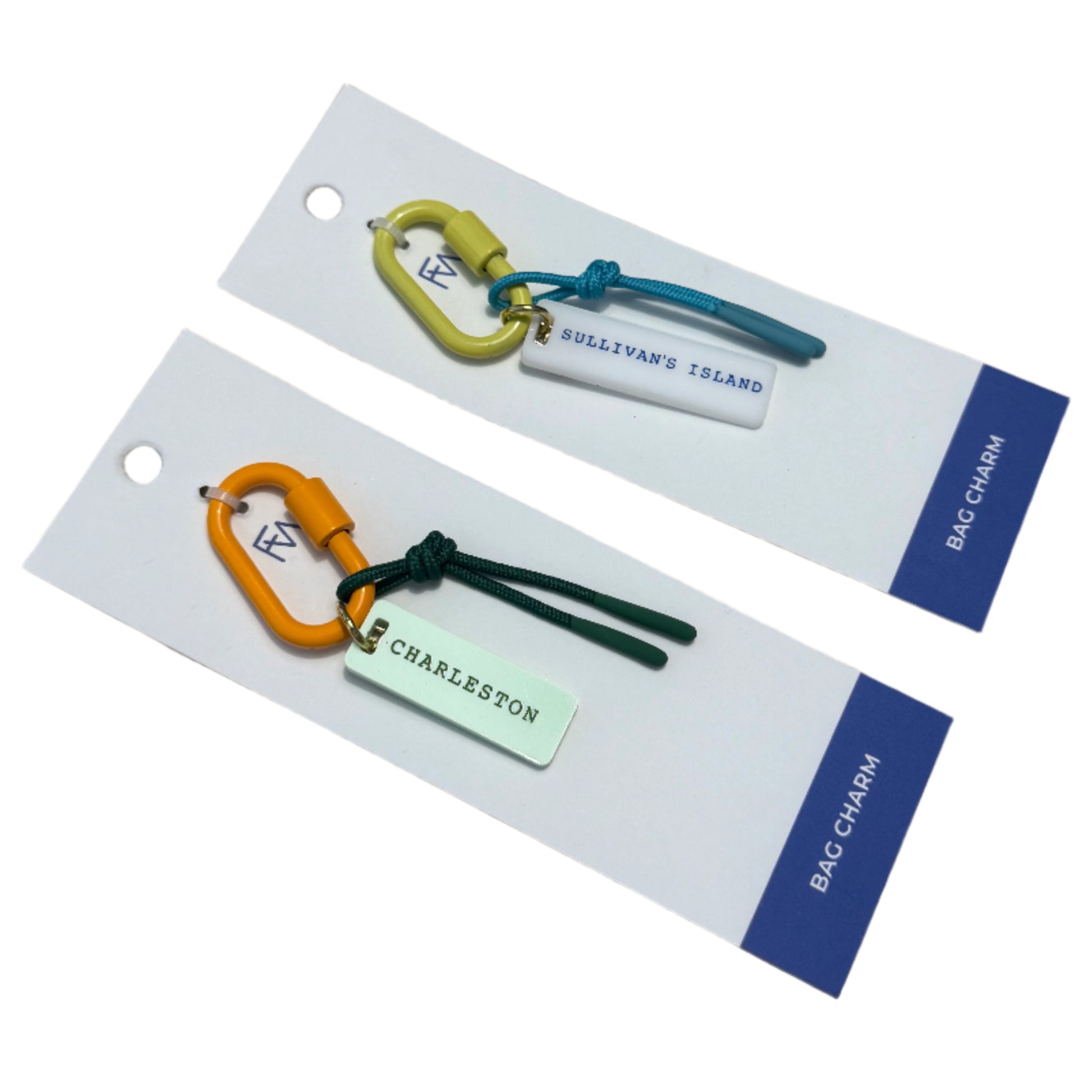 Two keychains on display cards with visible branding on a wooden surface.